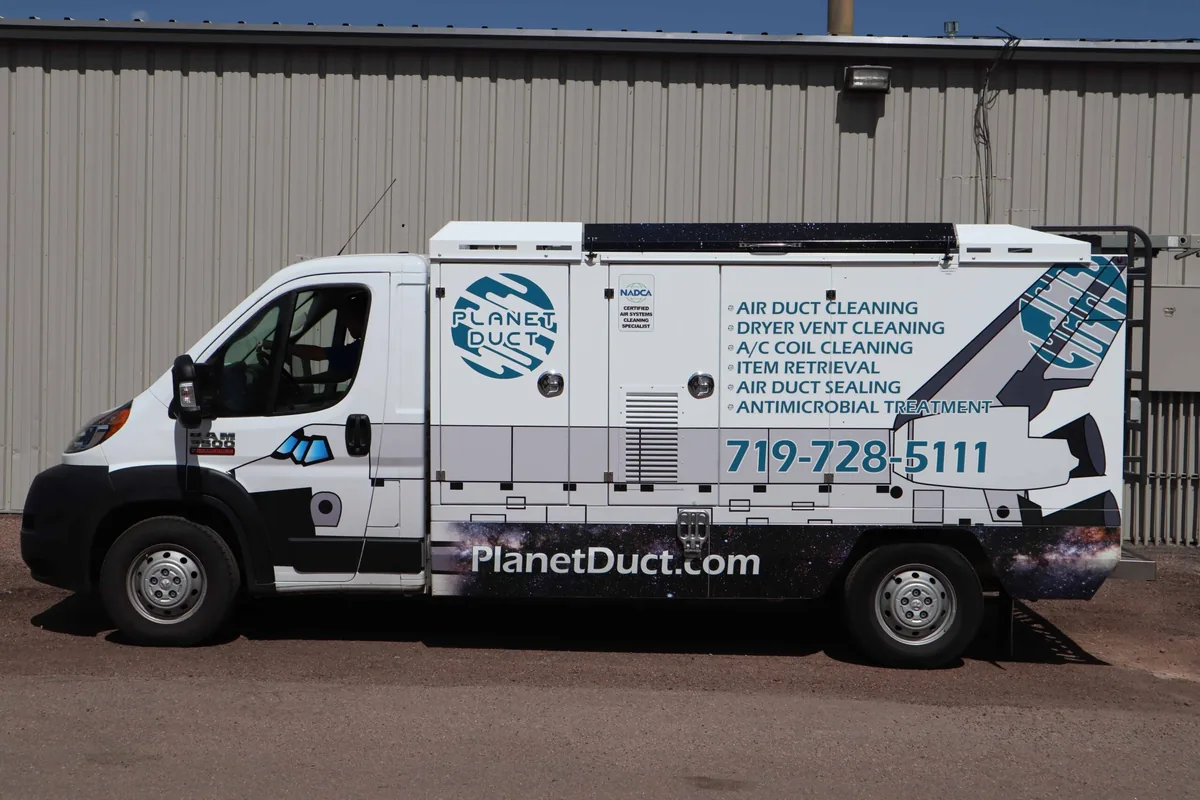 Planet Duct vehicle outside a building