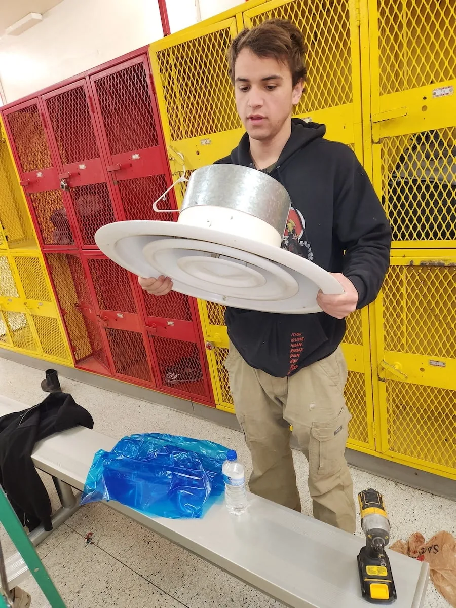 Planet Duct air duct cleaner inspecting a piece of ductwork